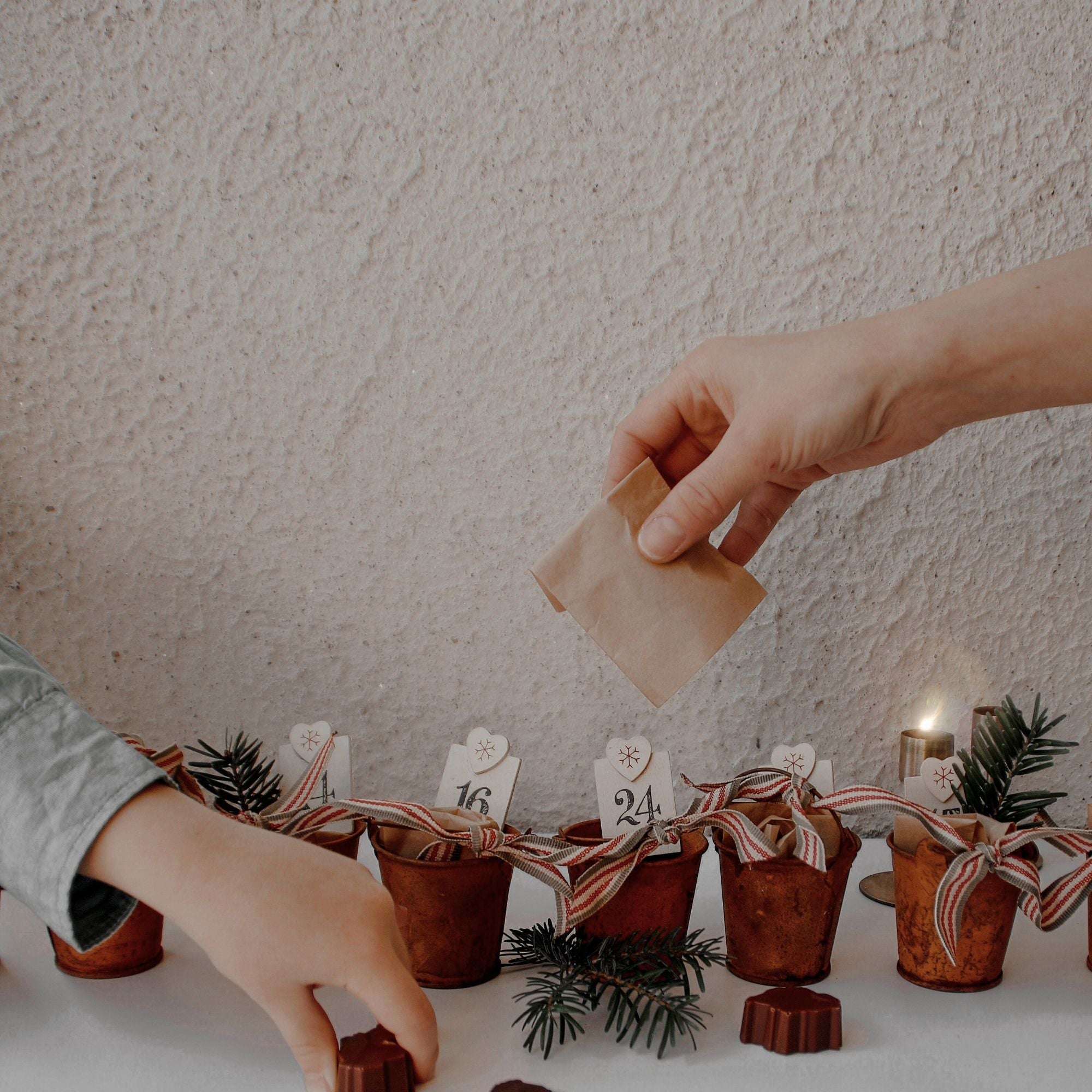 “Close view of Bean and Goose Advent Calendar with numbered boxes and ribbons, craft chocolate made in Ireland.”