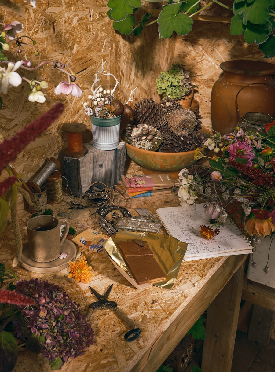 A potting table set with chocolate and autumn flowers