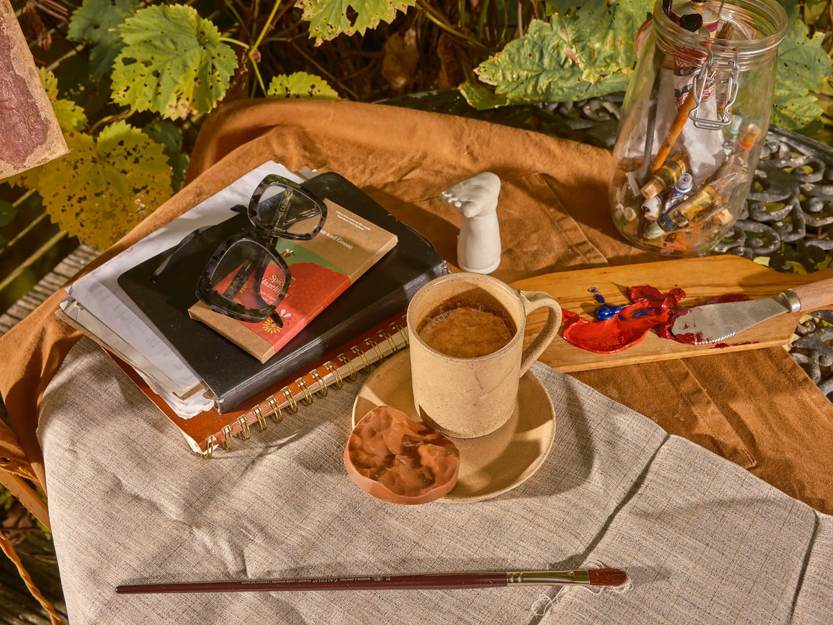 Hot chocolate and books on a winter table