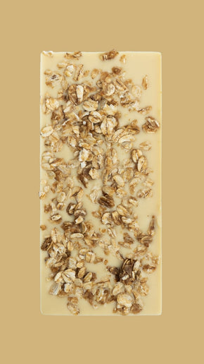 Bean and Goose Bar of white chocolate with toasted oats on a beige background