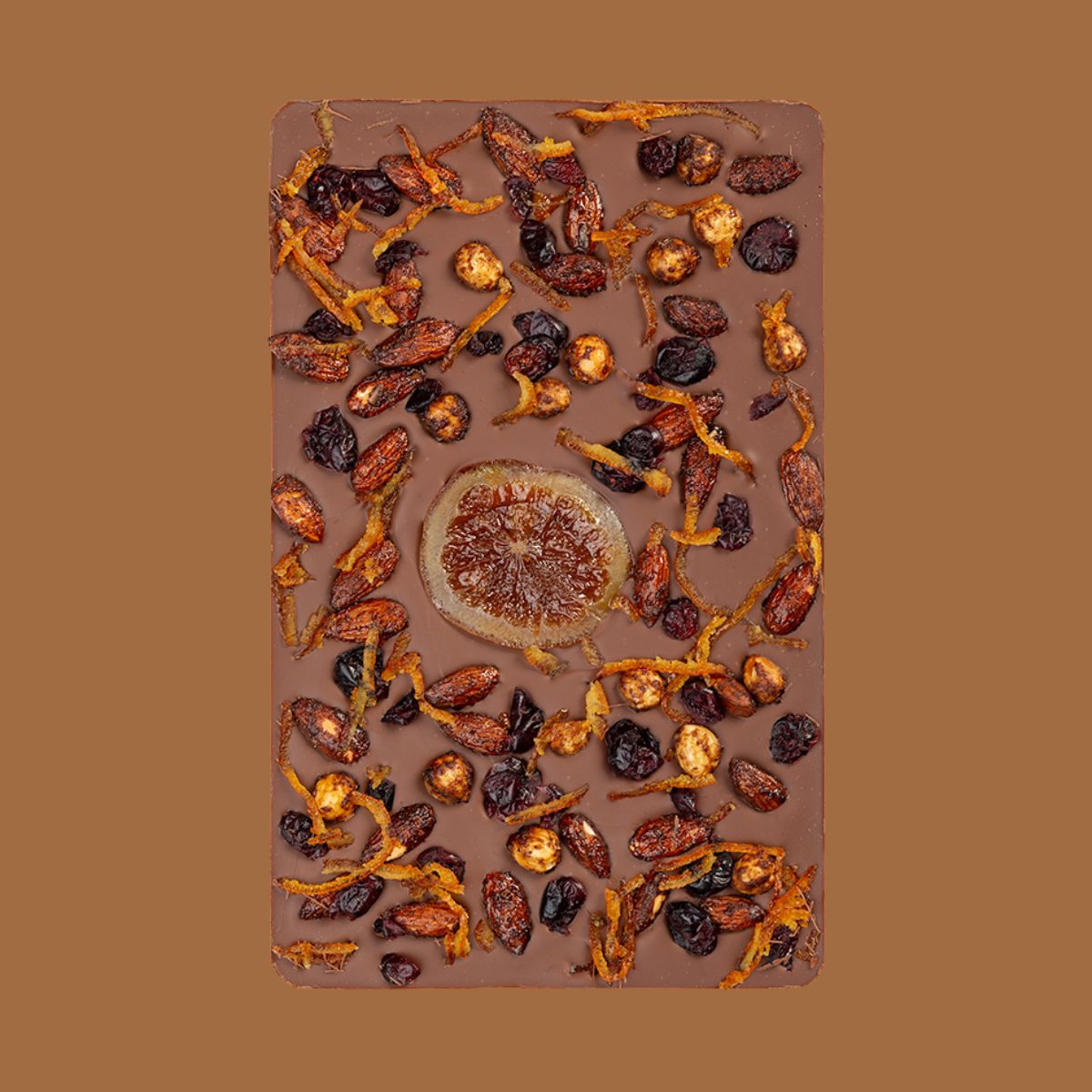 Chocolate bar with dried fruits and nuts on a brown background