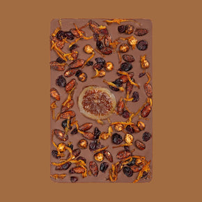Chocolate bar with dried fruits and nuts on a brown background