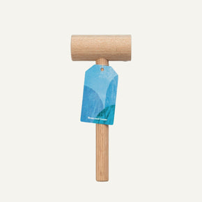 Wooden mallet with a blue tag on a white background