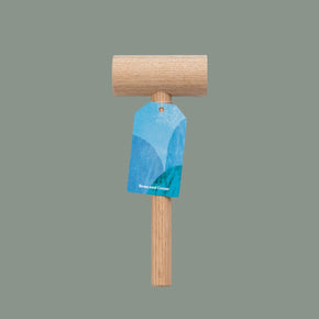 Wooden mallet with a blue tag on a gray background