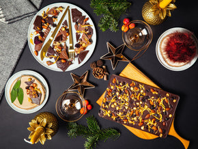Bean and Goose chocolate sharing slabs on a dark surface with decorative elements