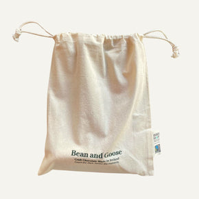Beige drawstring bag with 'Bean and Goose' branding on a white background