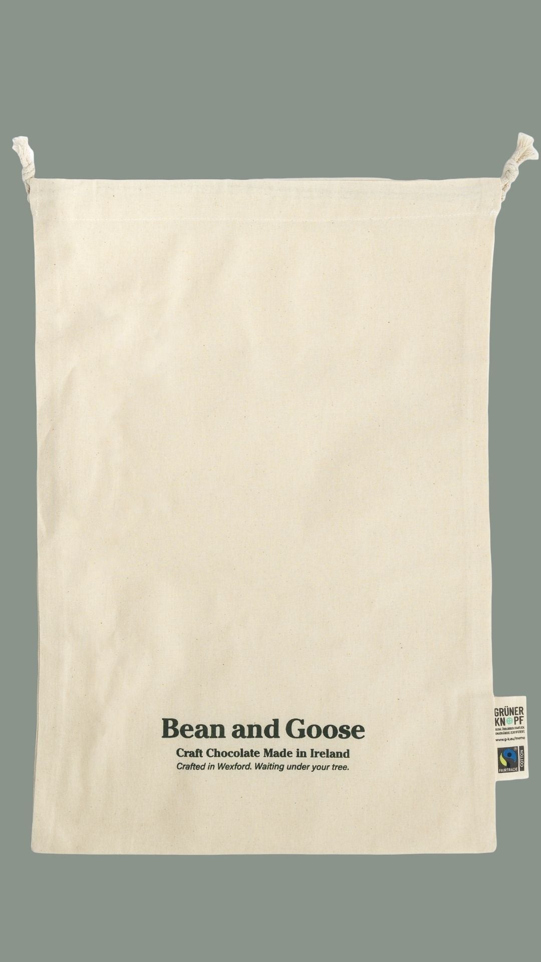 Beige drawstring bag with 'Bean and Goose' branding on a gray background