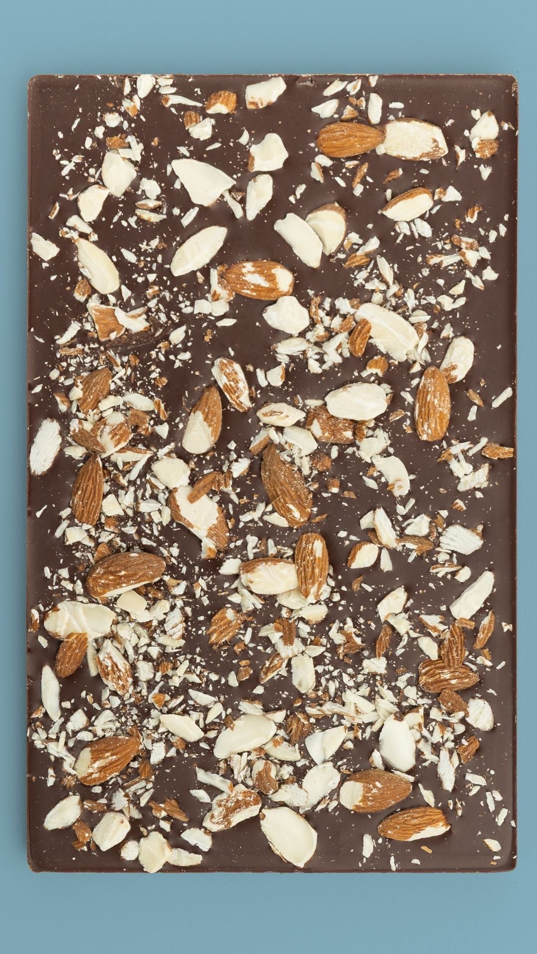 Bean and Goose Smoke & Stone Sharing Slab topped with almonds on a blue background