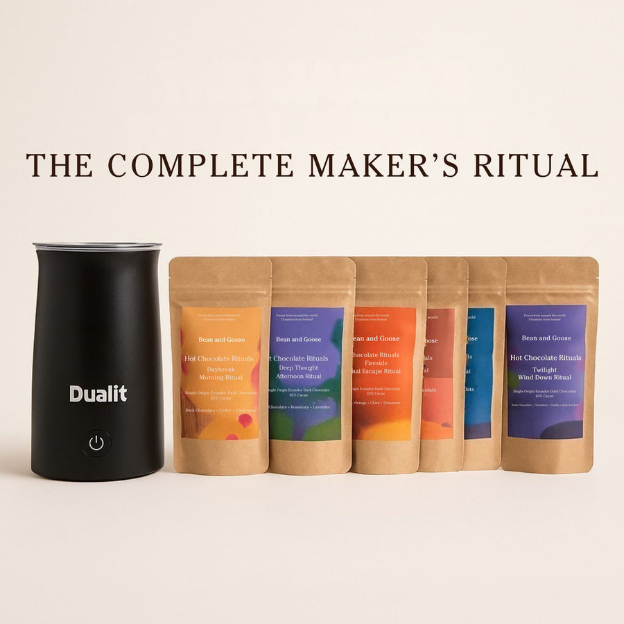 Black Dualit Hot Chocolate Maker with 6 Bean and Goose Hot Chocolate packaging on a beige background