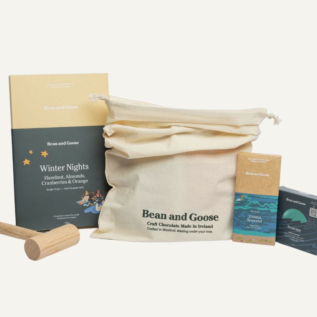 Bean and Goose chocolate packaging including a cotton bag, hammer of joy, and packaging on a white background