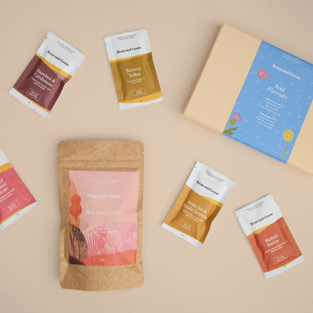 Bean and Goose all bar bundle assortment of chocolate bars, cafe bars and hot chocolate and packaging, with an emphasis on unique flavors and gift bundling.